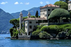 Beautiful view of the Villa del Balbianello overlooking Lake Como with mountains in the background