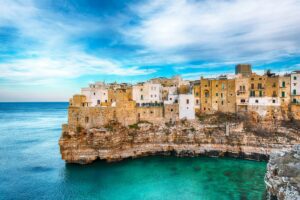 Polignano a Mare village on the rocks at sunset