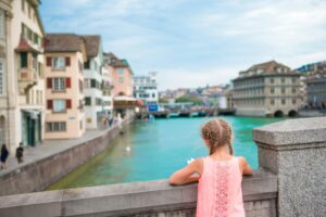 Adorable little girl outdoors in Zurich, Switzerland. Back view of beautiful kid background of cute