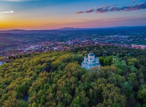 Aerial shot of St George Church in the middle of a forest in Oplenac, Topola, Serbia