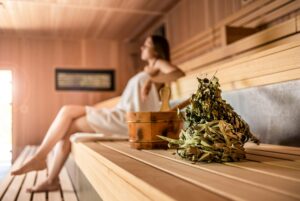 Beautiful young woman relaxing in Finnish sauna