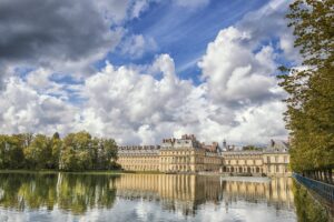 Chateau of Fontainebleau in France. Reflections on the water