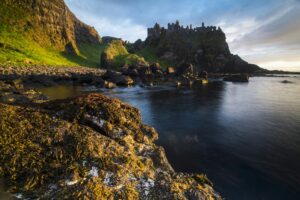 Dramatic coast and Dunluce Castle ancient ruins landscape, County Antrim, Northern Ireland