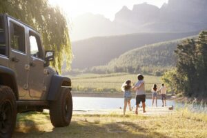 Excited Family Reaching Countryside Destination On Road Trip