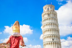 Family of father and little kid background the Learning Tower in Pisa. Pisa - travel to famous