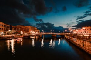 Long exposition on the illuminated harbour of Ortigia, Syracuse by night