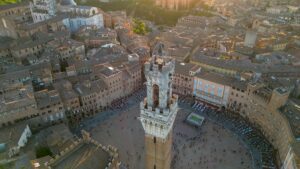 Siena at sunset, Piazza del Campo, Palazzo Pubblico, and Torre del Mangia, Italy