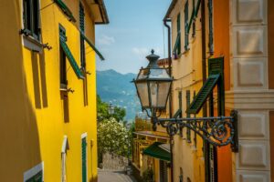 Small street with lamp and colorful walls, sunny day, Liguria region, Italy