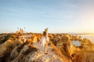 Woman traveling on the rocky coastline in Lagos, Portugal