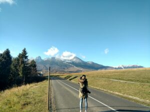 Young woman making beautiful photos of gorgeous mountains in Slovakia